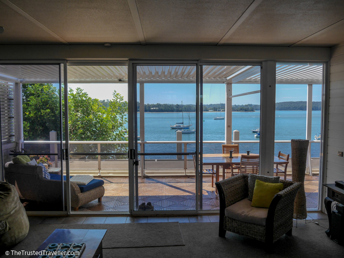 Looking out to the terrace and Clyde River from the living area - Bay Breeze Boutique Motel: Luxury on the Eurobodalla Coast - The Trusted Traveller